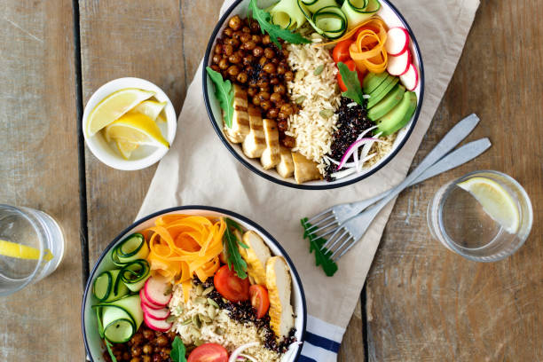 istock Top view two buddha bowl with lemon water on wooden table 972991408
