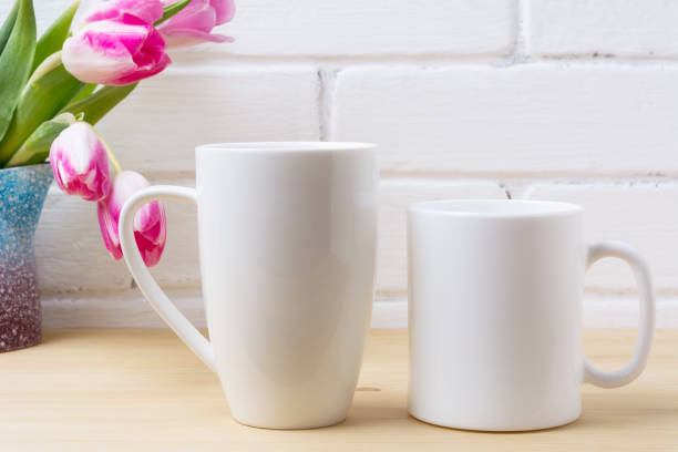 istock White coffee and cappuccino mug mockup with magenta tulip 973008630