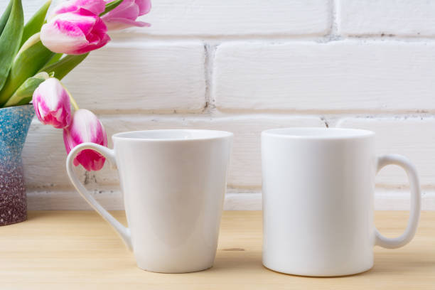 istock White coffee and latte mug mockup with magenta tulip 973008638