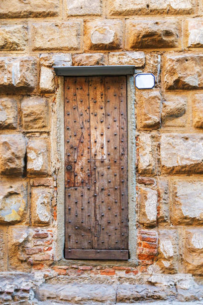istock Old wooden door and stone wall 973008954