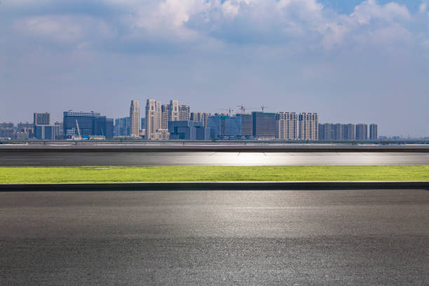 istock Panoramic skyline and modern business office buildings with empty road,empty concrete square floor 973011548