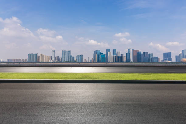 istock Panoramic skyline and modern business office buildings with empty road,empty concrete square floor 973011634