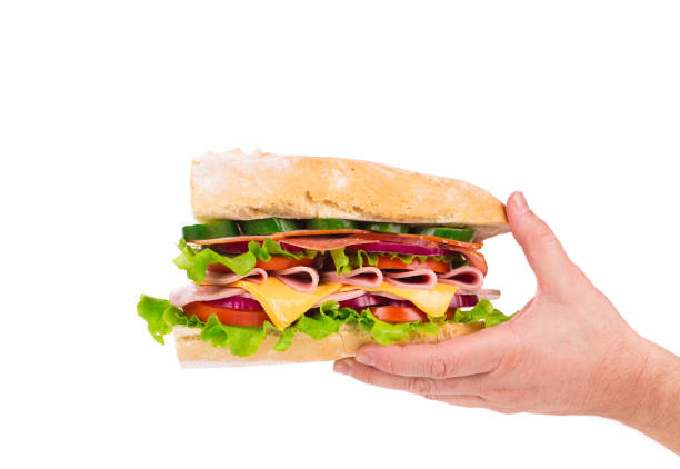 istock Sandwich with bacon and vegetables in hand. 973011860