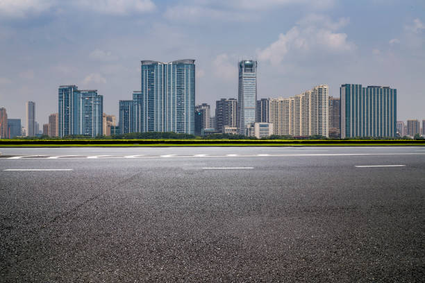 istock Panoramic skyline and modern business office buildings with empty road,empty concrete square floor 973011988