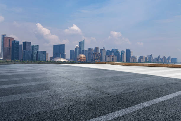 istock Panoramic skyline and modern business office buildings with empty road,empty concrete square floor 973016366