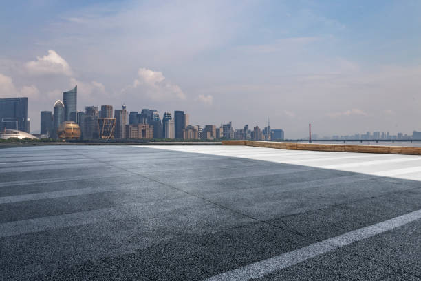 istock Panoramic skyline and modern business office buildings with empty road,empty concrete square floor 973016844