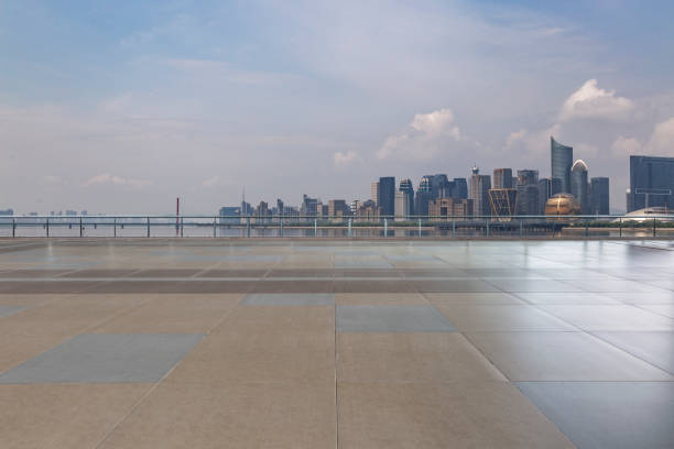 istock Panoramic skyline and modern business office buildings with empty road,empty concrete square floor 973016874