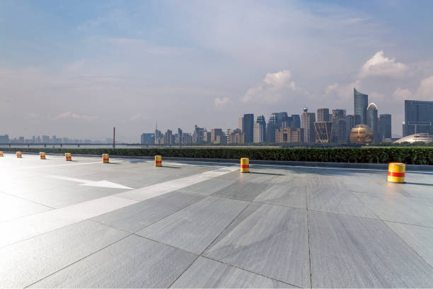 istock Panoramic skyline and modern business office buildings with empty road,empty concrete square floor 973016876
