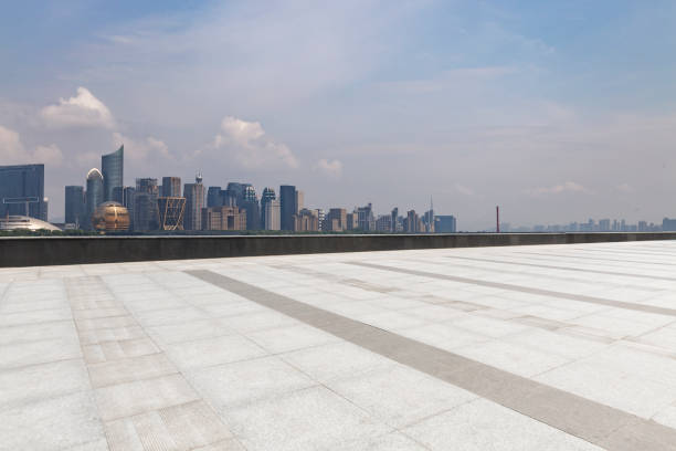 istock Panoramic skyline and modern business office buildings with empty road,empty concrete square floor 973017006
