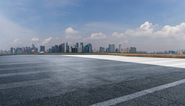 istock Panoramic skyline and modern business office buildings with empty road,empty concrete square floor 973017092