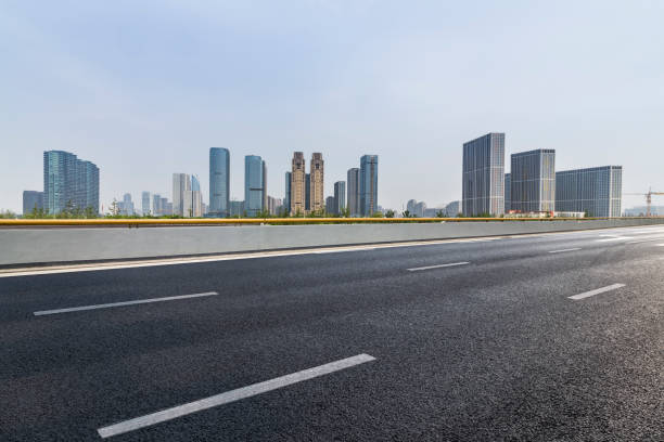 istock Panoramic skyline and modern business office buildings with empty road,empty concrete square floor 973017830
