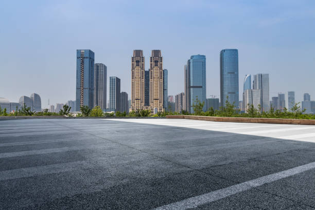istock Panoramic skyline and modern business office buildings with empty road,empty concrete square floor 973019356