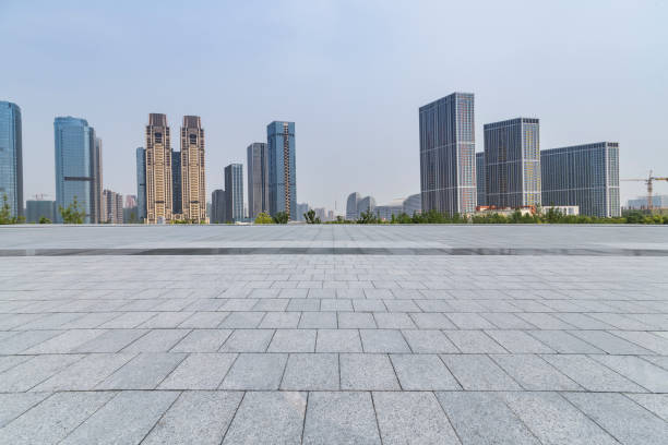 istock Panoramic skyline and modern business office buildings with empty road,empty concrete square floor 973019614