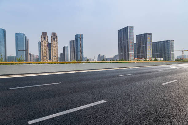 istock Panoramic skyline and modern business office buildings with empty road,empty concrete square floor 973019732
