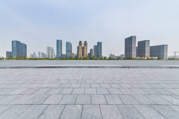istock Panoramic skyline and modern business office buildings with empty road,empty concrete square floor 973019860