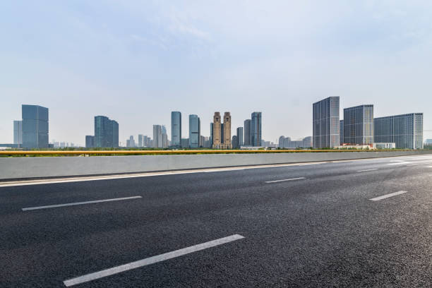 istock Panoramic skyline and modern business office buildings with empty road,empty concrete square floor 973022646