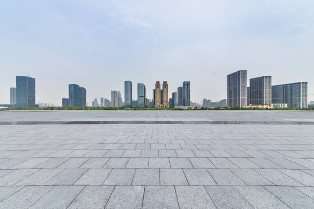 istock Panoramic skyline and modern business office buildings with empty road,empty concrete square floor 973022984