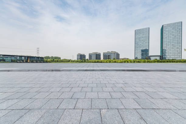istock Panoramic skyline and modern business office buildings with empty road,empty concrete square floor 973025080