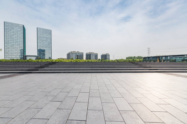 istock Panoramic skyline and modern business office buildings with empty road,empty concrete square floor 973025282