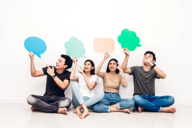 istock Group of friends holding a speech bubble icon 973028230