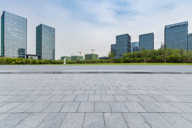 istock Panoramic skyline and modern business office buildings with empty road,empty concrete square floor 973035976