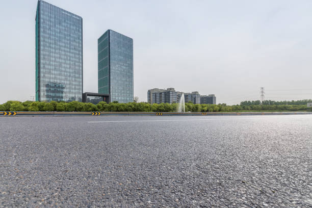 istock Panoramic skyline and modern business office buildings with empty road,empty concrete square floor 973038770