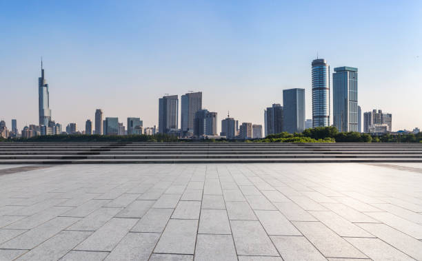 istock Panoramic skyline and modern business office buildings with empty road,empty concrete square floor 973050124
