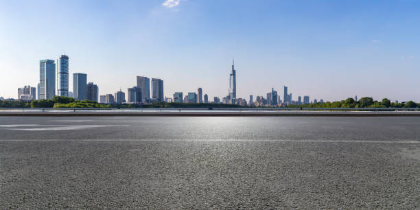 istock Panoramic skyline and modern business office buildings with empty road,empty concrete square floor 973050306