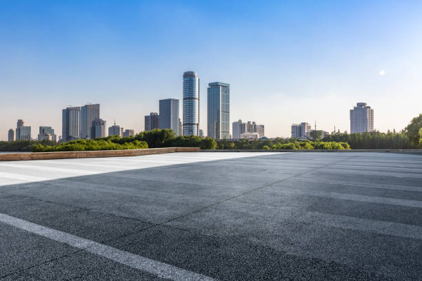 istock Panoramic skyline and modern business office buildings with empty road,empty concrete square floor 973050700