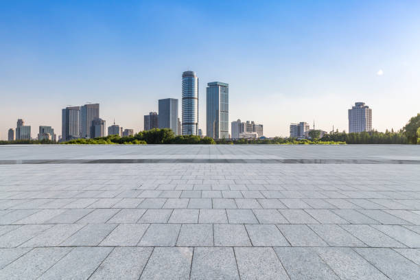 istock Panoramic skyline and modern business office buildings with empty road,empty concrete square floor 973050718