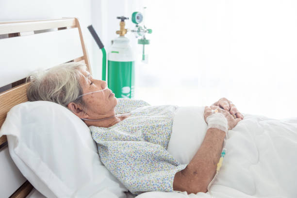 istock senior female patient sleeping on bed 973050748