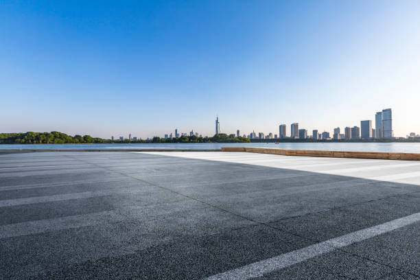 istock Panoramic skyline and modern business office buildings with empty road,empty concrete square floor 973051122