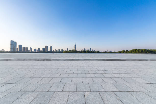 istock Panoramic skyline and modern business office buildings with empty road,empty concrete square floor 973051160