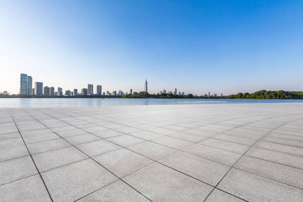 istock Panoramic skyline and modern business office buildings with empty road,empty concrete square floor 973053386