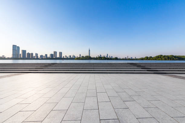 istock Panoramic skyline and modern business office buildings with empty road,empty concrete square floor 973053396