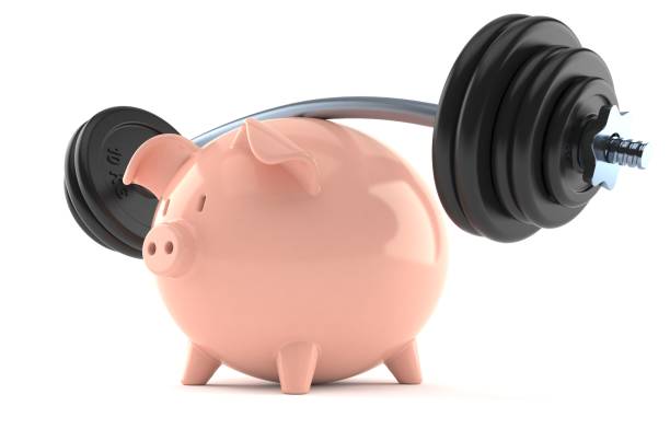 istock Piggy bank with barbell 973056896