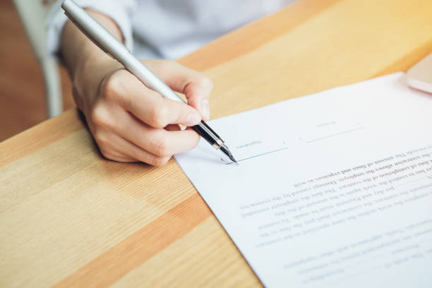 istock closeup of signing a documentation agreement and pen on the table. 973060708