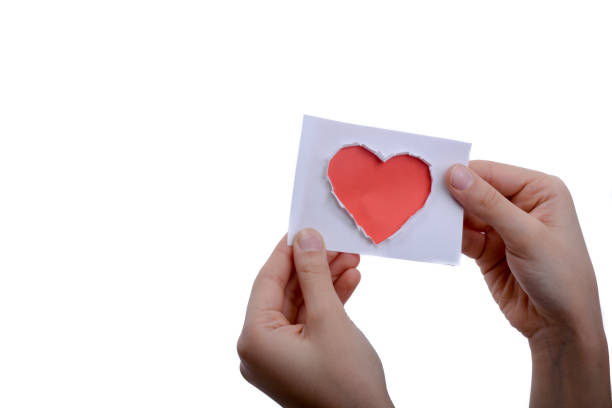 istock Red heart shape paper in hand 973063392