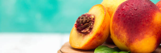 istock a lot of fresh peaches on a white table banner 973063848