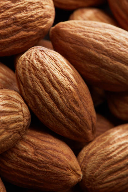 istock almonds close up as background, macro shot 973064014