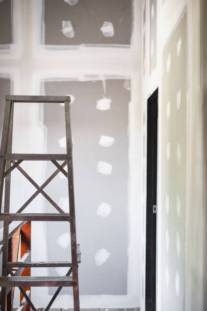 istock Stair in empty room interior new ceiling plaster gypsum board in construction site. 973066786