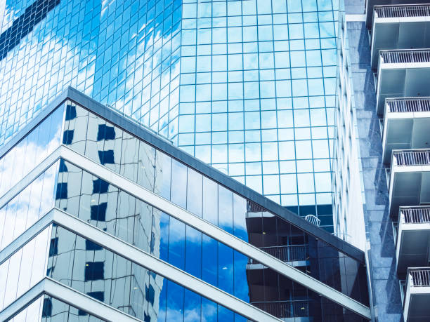 istock blue sky and clouds reflected on glass building 973069398