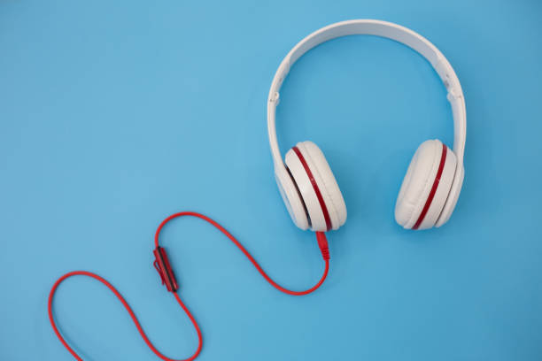 istock White headphones on blue background. 973070360
