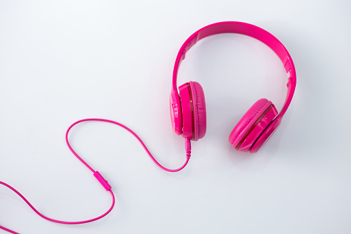 Pink headphones on a white background.