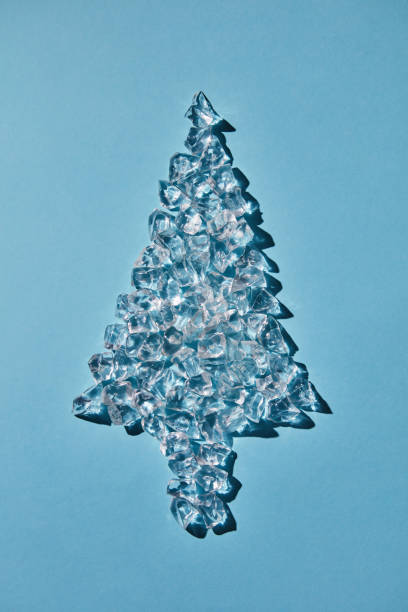 istock Christmas tree of ice cubes on a blue background 973070394