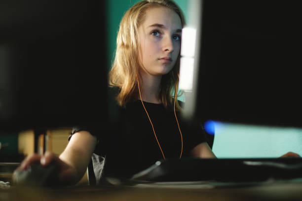 Teenage girl working or gaming on computer