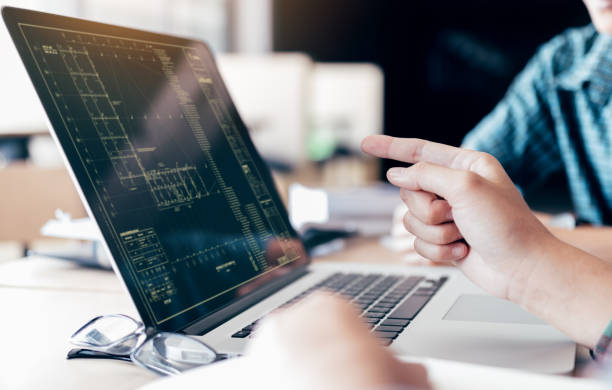 istock Teenagers develop programming with blueprint code in laptop monitor. 973074712
