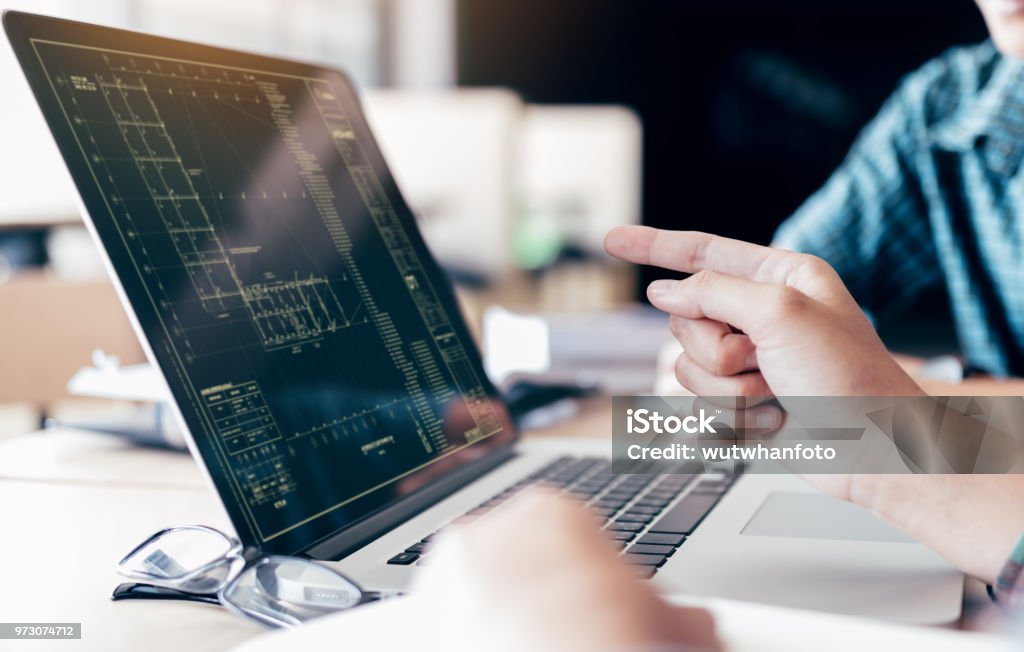 Teenagers develop programming with blueprint code in laptop monitor. Engineer Stock Photo