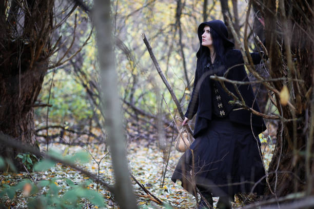istock A woman in a witch suit in a forest 973074832
