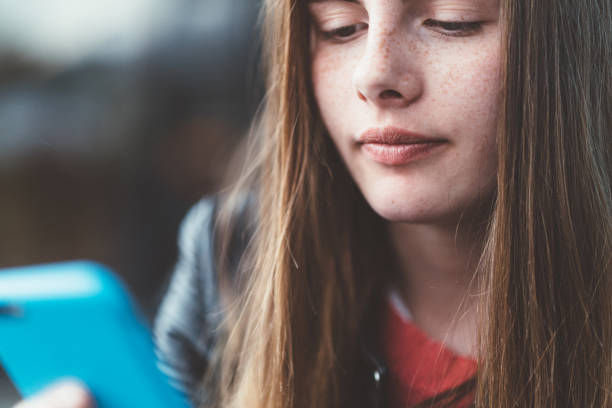 Portrait of an Authentic girl of 12 years old with Down Syndrome in daily lives. Due to their differing abilities, those children have always something in her hands for playing. Photo was taken in Quebec Canada.